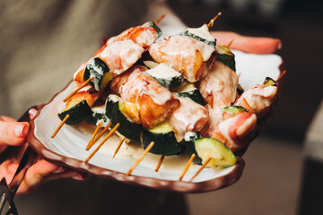 Waiter in uniform serving dishes on party event, server carrying plates with food at the table, catering service on wedding reception, cafe restaurant table service, waiters arranging dinner banquet