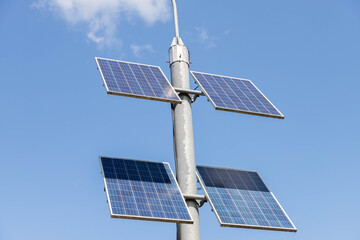 Pole mounted with solar panels and lights led illuminating.