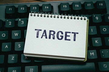 There is notebook with the word Target. It is as an eye-catching image.