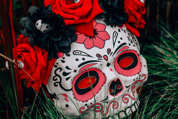 Skull Mask on a Pumpkin Outdoors.Day of the Dead Background.Death mask on pumpkin in red...