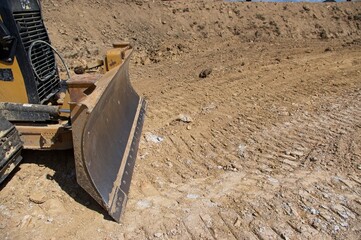 Front blade of a bulldozer on a construction site
