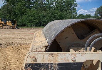Side view of roller compactor on construction site