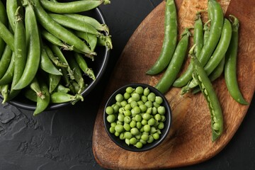 Fresh ripe green peas on black table, flat lay