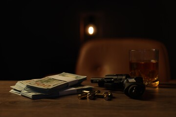 Gun, bullets, money and whiskey on wooden table in mafia boss office