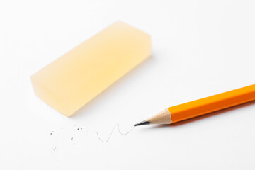 Pencil and eraser on white background, closeup