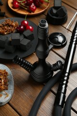 Traditional hookah parts, tobacco, charcoal cubes and cherries on wooden table, closeup