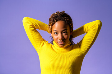 Young african american model showing confidence and empowerment with hands behind head