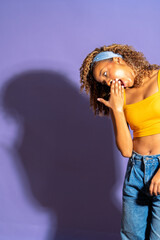 Young woman yawning and covering mouth with hand