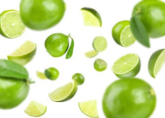 Fresh ripe limes flying on white background
