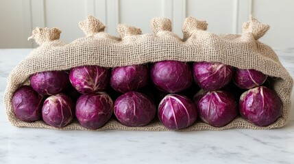Red cabbages in burlap sack with a beautiful marble background providing a rustic aesthetic