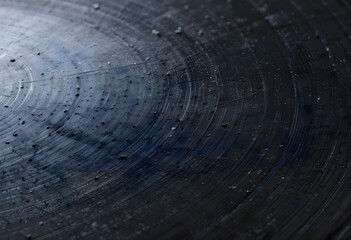 Macro shot of metallic plate with visible water droplets forming texture and shine, clean surface with detail reflections