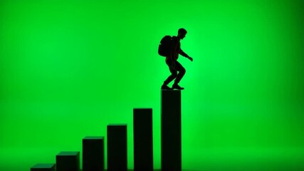 Silhouette figure climbs upward on a graph success concept.