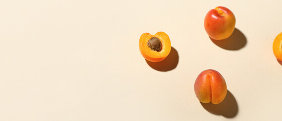 Fresh apricots on beige background