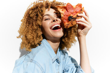 Happy young woman enjoying pizza slice, showcasing vibrant personality and healthy lifestyle in a...