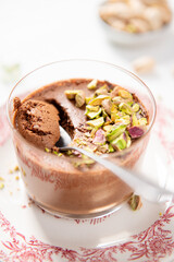 A decadent chocolate dessert, beautifully topped with vibrant pistachios