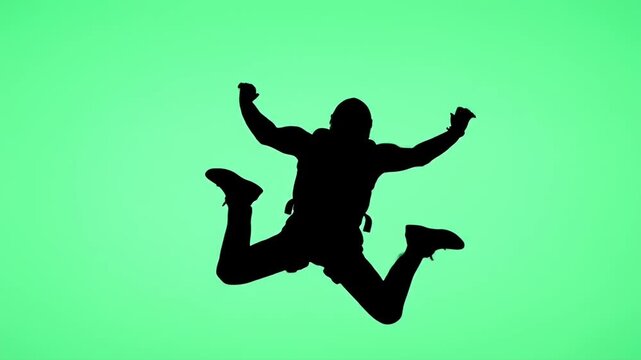 Person Jumping Against Green Screen Background - Silhouette in Air