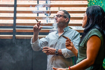 Business partners smoking cuban cigars and drinking spirits