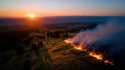 Aerial View of Wildfire Spreading Through Grassland at Sunset