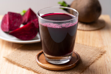Fresh beetroot juice in glass on wooden board, Healthy drink
