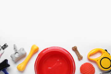 Food bowl and different pet accessories on white background