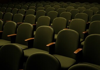Naklejka premium A dimly lit hall features many rows of unoccupied dark green theater seats with wooden armrests