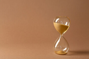 Crystal hourglass on beige background