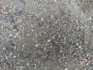 Mixed Gravel and Small Stones Texture. A close-up, full-frame view of a surface composed of various sizes and colors of gravel and small pebbles
