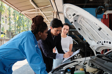Latino female client and Asian male manager discuss Black mechanic about EV car engine fix claims...