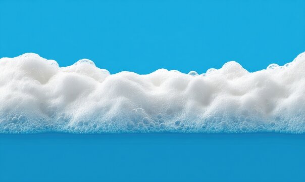 Frothy white bubbles border a vibrant blue background