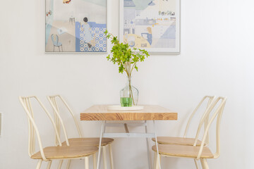 A cozy dining area with light-colored chairs and a small table