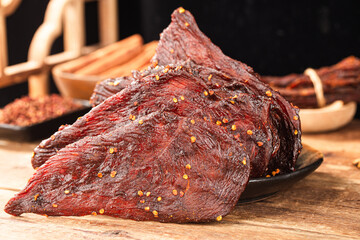 Dried chicken meat. Tasty jerky meat on cutting board.