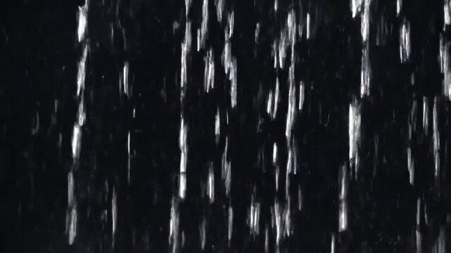 Seamlessly looped close-up animation of vertical falling rain, realistic raindrops forming a dense rain wall. Real rainstorm VFX insert style. Dark black background. 4K resolution, ultra-detailed, cin