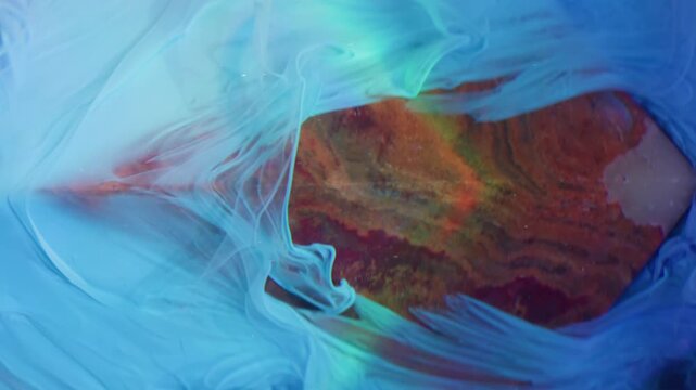 Vertical video. Ink spread. Acrylic stream. Pyramid stone onyx shape blue pigment pour slide black background underwater abstract art blur rainbow light ray.