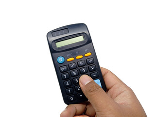 A hand is holding and pressing buttons on a dark-colored calculator with yellow and blue accents, isolated against a bright white background, conveying action in calculation or accounting.