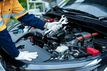 Asian male automotive technician who inspects, repairs, and maintains all vehicle systems,ensuring...
