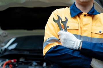Asian male automotive technician who inspects, repairs, and maintains all vehicle systems,ensuring...