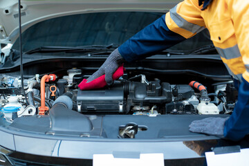 Asian male automotive technician who inspects, repairs, and maintains all vehicle systems,ensuring...
