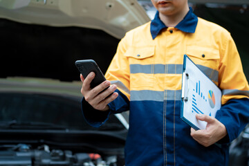 Asian male automotive technician who inspects, repairs, and maintains all vehicle systems,ensuring...
