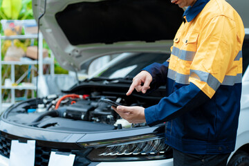 Asian male automotive technician who inspects, repairs, and maintains all vehicle systems,ensuring...