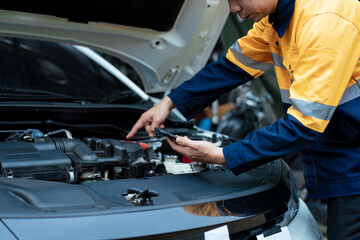 Asian male automotive technician who inspects, repairs, and maintains all vehicle systems,ensuring safe and optimal performance through expertise in engines, brakes, transmissions electrical systems