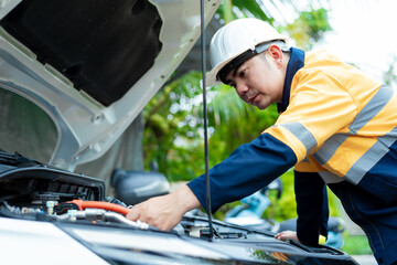 Asian male automotive technician who inspects, repairs, and maintains all vehicle systems,ensuring...