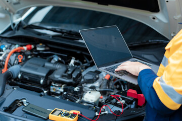 Asian male automotive technician who inspects, repairs, and maintains all vehicle systems,ensuring...