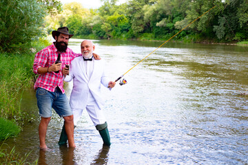 Fisherman men friends and trophy trout. Father and son fishing. Generations men fishing in river.