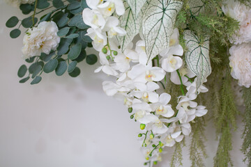 White orchid flower with green leaves decorated on white background