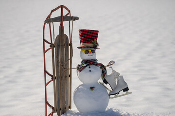 Obraz premium Snowman on snow background. Winter holiday scene. Snowman with scarf and hat. Snow design. Happy snowman outdoor. Snow banner. Frosty snowman. Winter greeting card. Cute snow man.