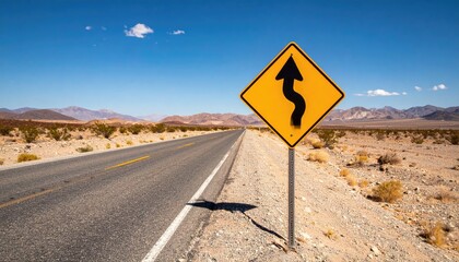 Winding road sign in desert landscape