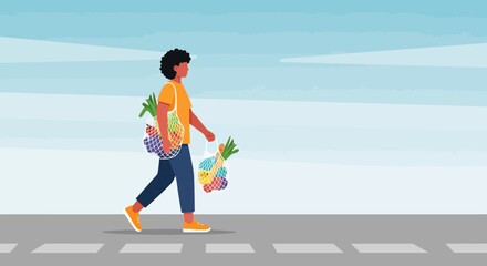 Person walking across crosswalk carrying fresh produce in reusable bags.