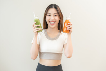 Orange, green detox juice, smile asian young woman hand holding bottle of vegetable juice, carrot...