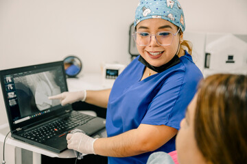 Dental professional explaining x ray results to patient
