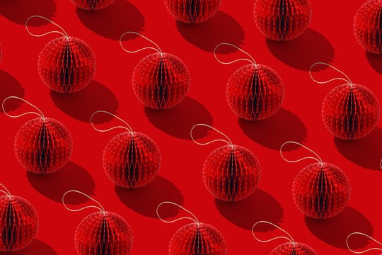 Paper Christmas Ornaments, hanging red New Year decorations as round balls. Minimal aesthetic holidays pattern, red monochrome design, repeated arrangement, winter Eco-friendly decoration features